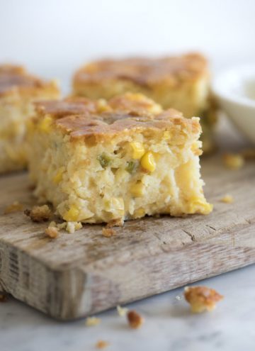 photo of moist jalapeño cornbread pudding on a wooden cutting board