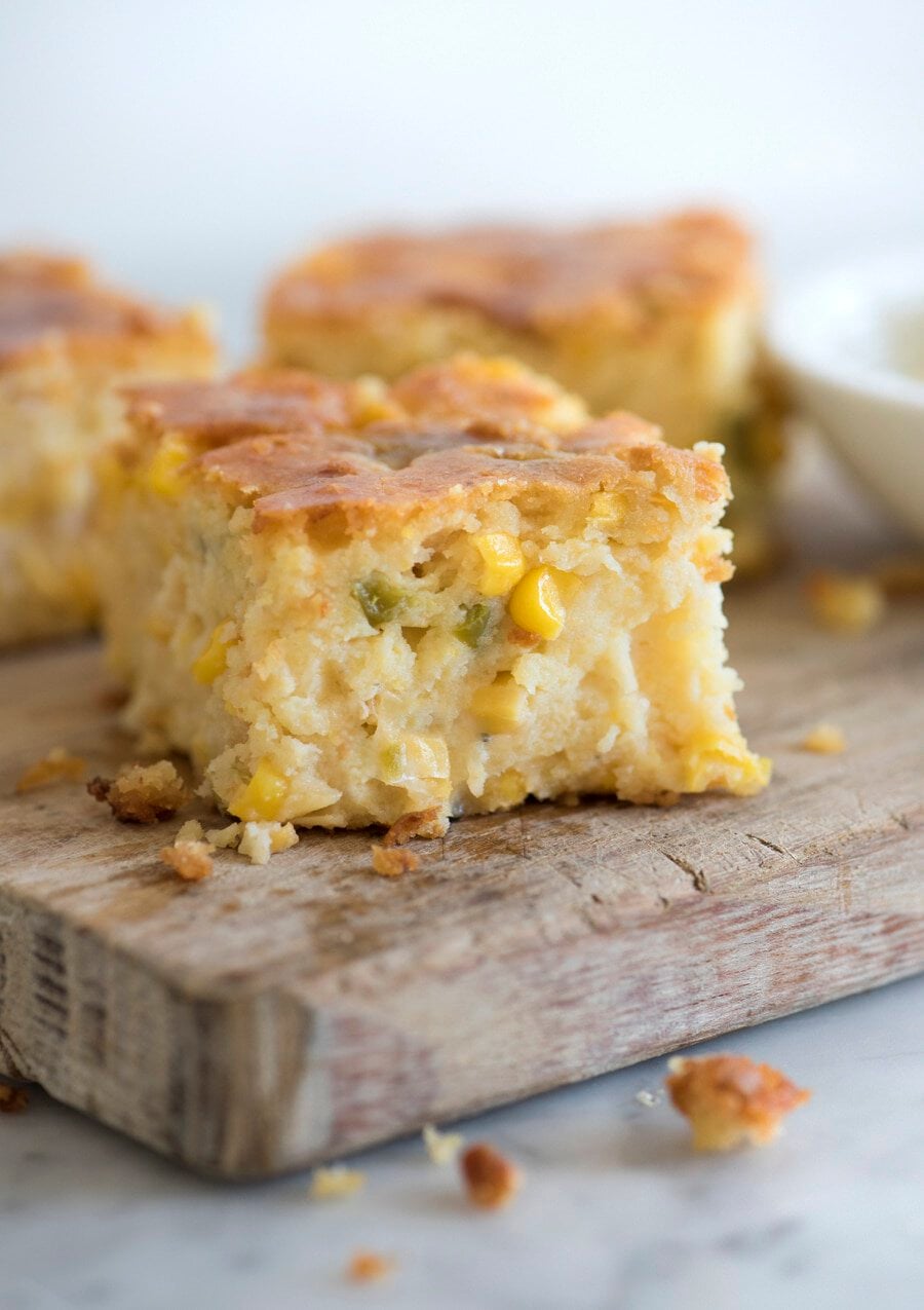 photo of moist jalapeño cornbread pudding on a wooden cutting board