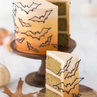piece of three layered halloween cake with bat decor
