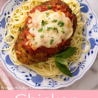 A pinterest graphic of chicken parmesan over a plate of spaghetti.