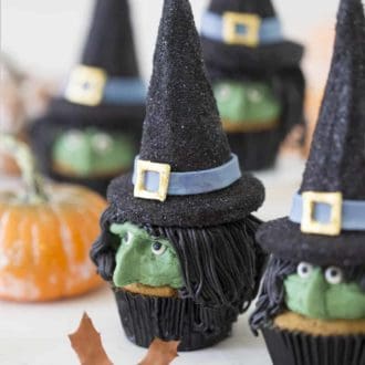 Halloween witch cupcakes in black cupcake papers.