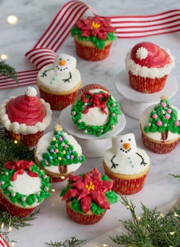 A photo of Christmas cupcakes on a white marble table.