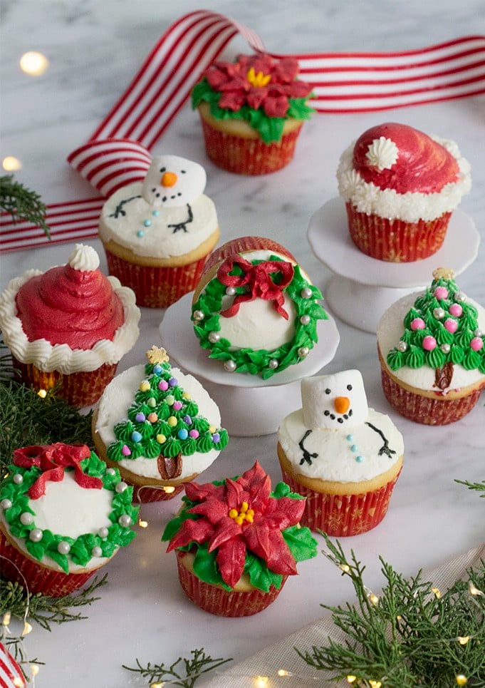 A photo of Christmas cupcakes on a white marble table.