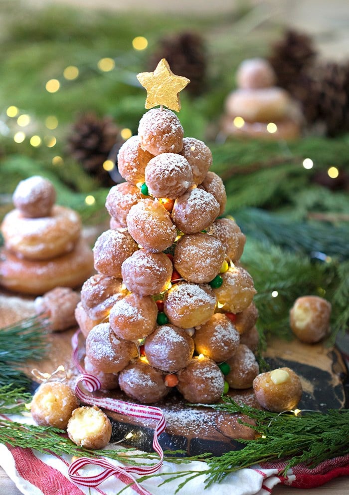A photo showing a crquembouche made from donut holes with LED mini lights
