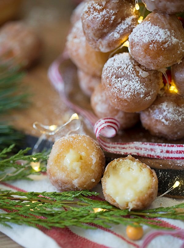 A close up photo showing the inside of a vanilla pudding filled donut hole.