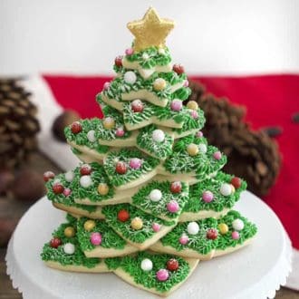 A Christmas Cookie tree on a white cake stand.