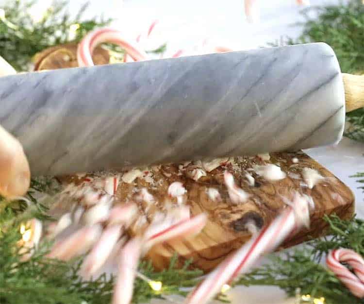 Candy canes being crushed with a marble rolling pin.
