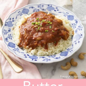 Butter chicken on a blue and white plate.