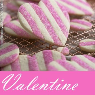 a photo for pinterest of pink and white heart-shaped valentine cookies.