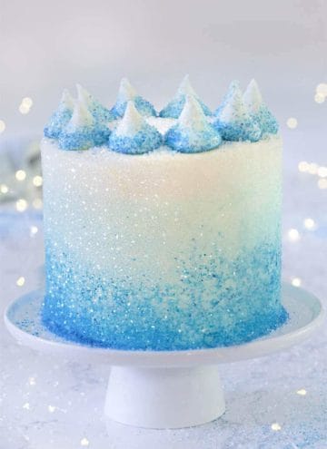 A winter sparkle cake on a cake stand.