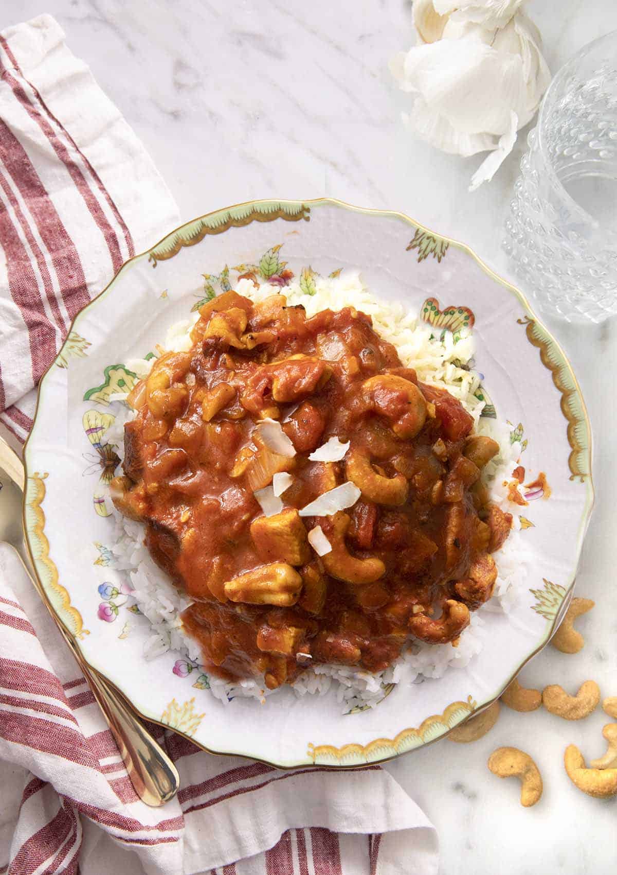 Butter chicken on a plate garnished with coconut.
