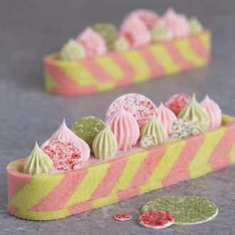 A striped pink and green strawberry matcha tart