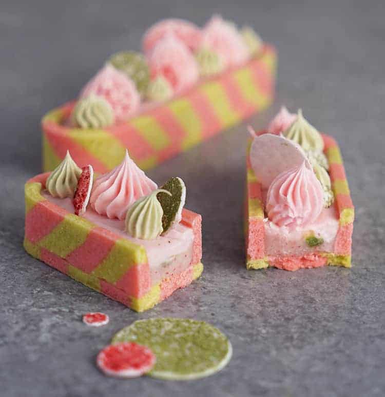 two strawberry mnatcha tarts. One has been cut in half exposing the filling