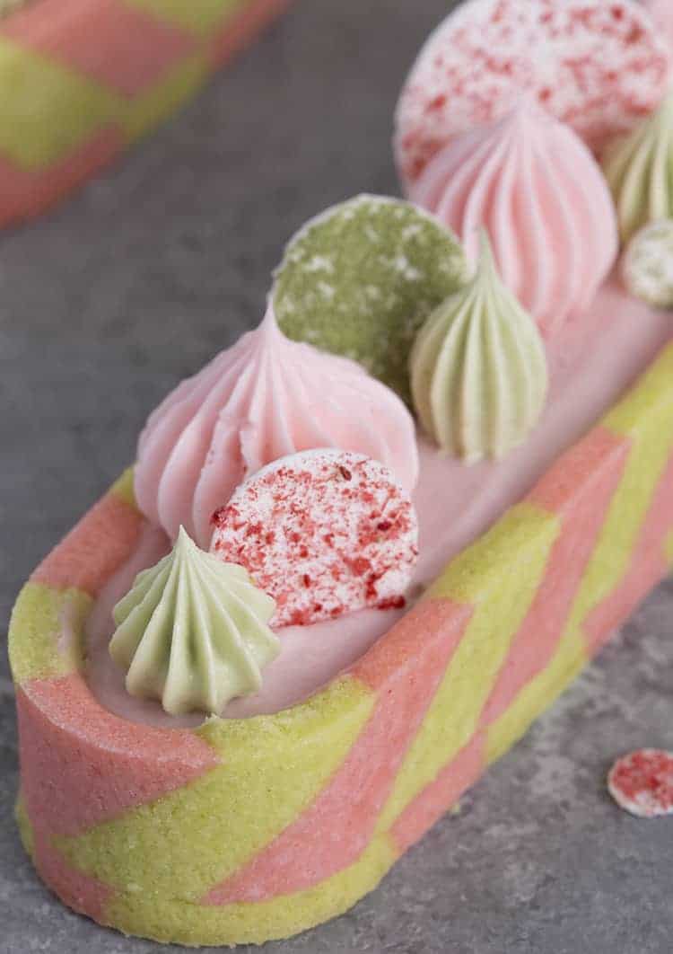 a closeup photo of a pink and green tast with dollops and circles on top