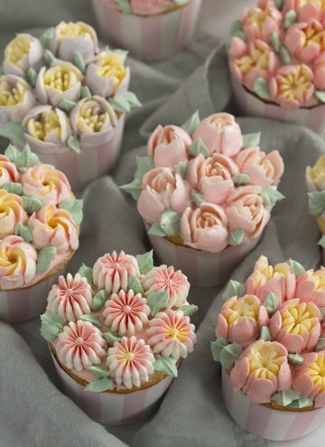 a photo of cupcakes topped with buttercream flowers using Russian piping tips
