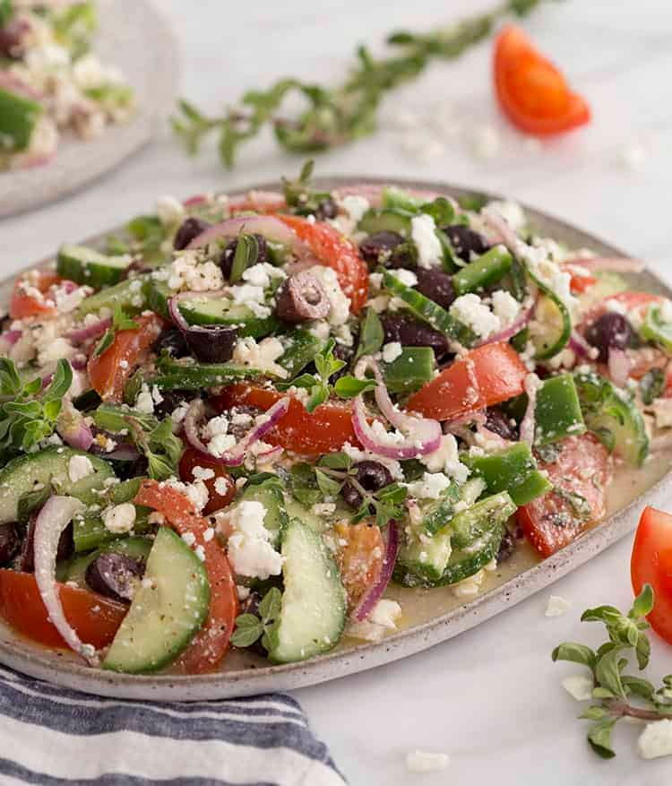 A large Greek salad on a white platter