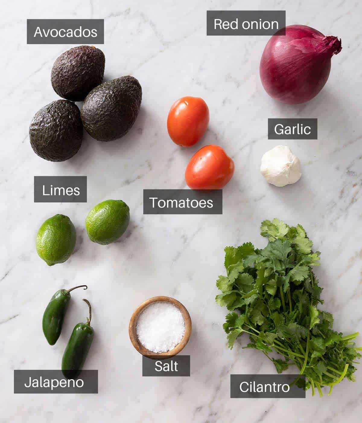 An overhead shot of all the ingredients you need to make guacamole.