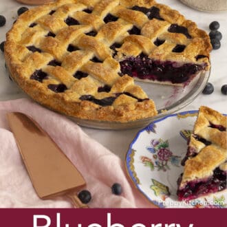 Pinterest graphic of a blueberry pie with a slice of pie on plate.