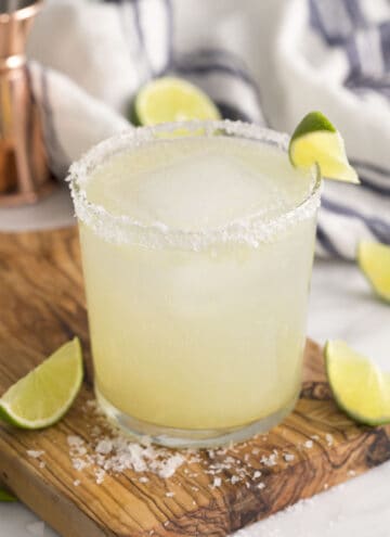 A from-scratch margarita in a tumbler garnished with a lime wedge.