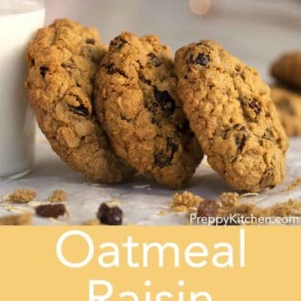 oatmeal raisin cookies leaning on a glass of milk