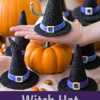 Pinterest graphic of a hand holding up a white hat cookie. More cookies surrounding it.