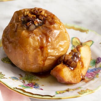 A baked apple on a porcelain plate.