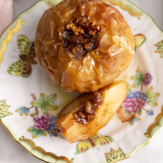 Pinterest graphic of a baked apple on a porcelain plate with a slice of apple on it.