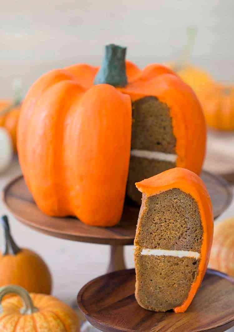 A large pumpkin-shaped cake covered with orange buttercream.