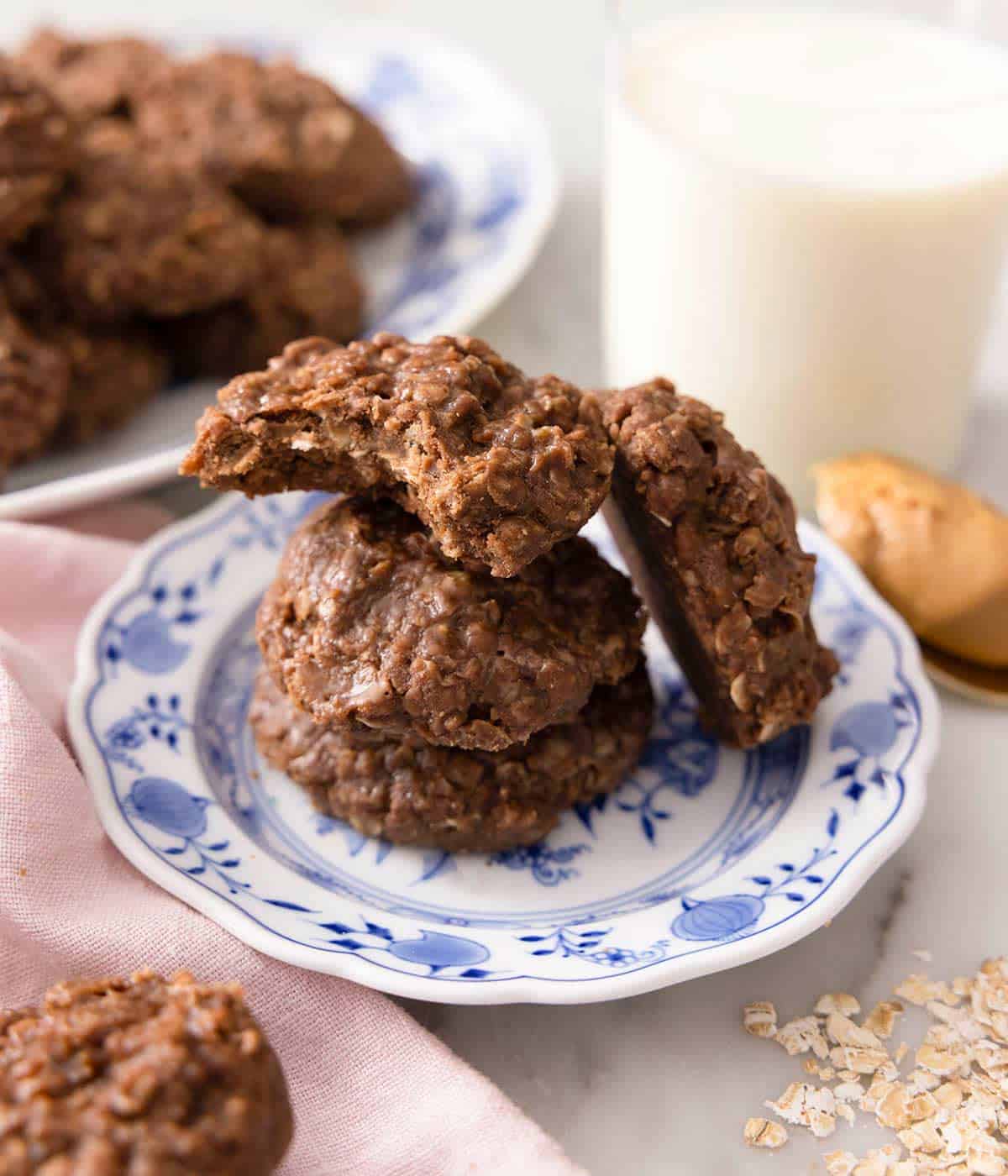 Three no bake cookies on a small blue plate in a stack.