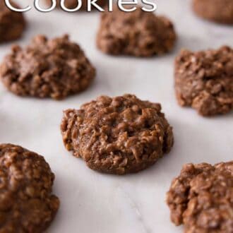 A pinterest graphic of a single layer of no bake cookies on a marble surface.