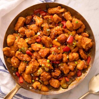 An overhead shot of sweet and sour chcken in a skillet
