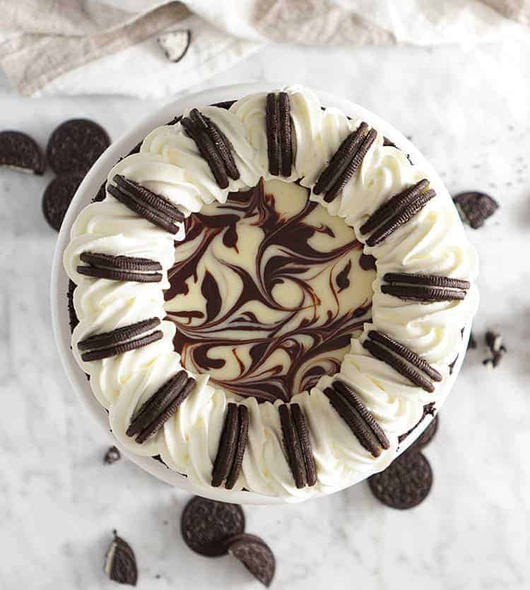 A top down view of an Oreo Cheesecake on a marble table.