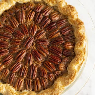 Pinterest graphic of a pecan pie on a marble counter.