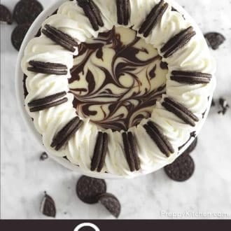 Pinterest graphic of an overhead view of Oreo cheesecake on a cake stand.