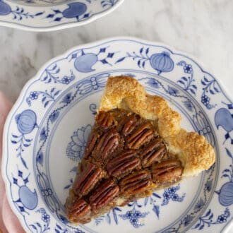 Pinterest graphic of a piece of pecan pie on a blue and white plate.