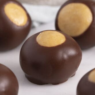 closeup of 3 buckeyes on a white surface