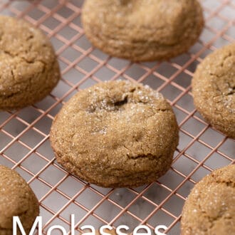 Pinterest graphic of a group of molasses cookies on a cooling rack.