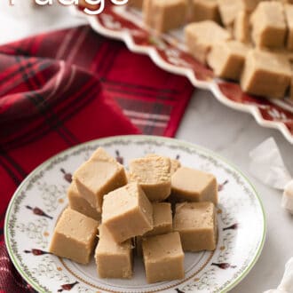 Pinterest graphic of peanut butter fudge pieces on a holiday themed plate. Platter in the background.