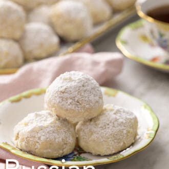 Pinterest graphic of three Russian tea cakes sitting on a plate with a pink napkin.