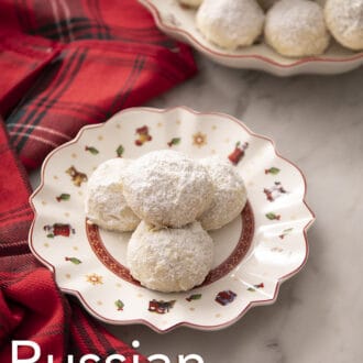 Pinterest graphic of Russian tea cakes on a Christmas themed plate with a plaid napkin.