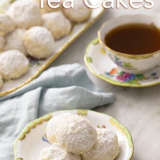 Pinterest graphic of Russian tea cakes on a white and green plate with a cup of tea. Platter in the back.