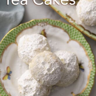 Pinterest graphic of close up photo of Russian tea cakes on a plate.