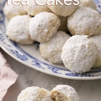 Pinterest graphic of Russian tea cakes on a blue and white patterned plate with two in front on the counter.
