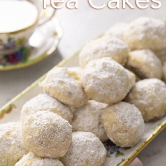 Pinterest graphic of several Russian tea cakes on a porcelain tray.