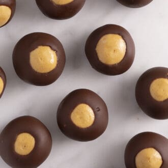 overhead image of several buckeyes spread across a white marble counter