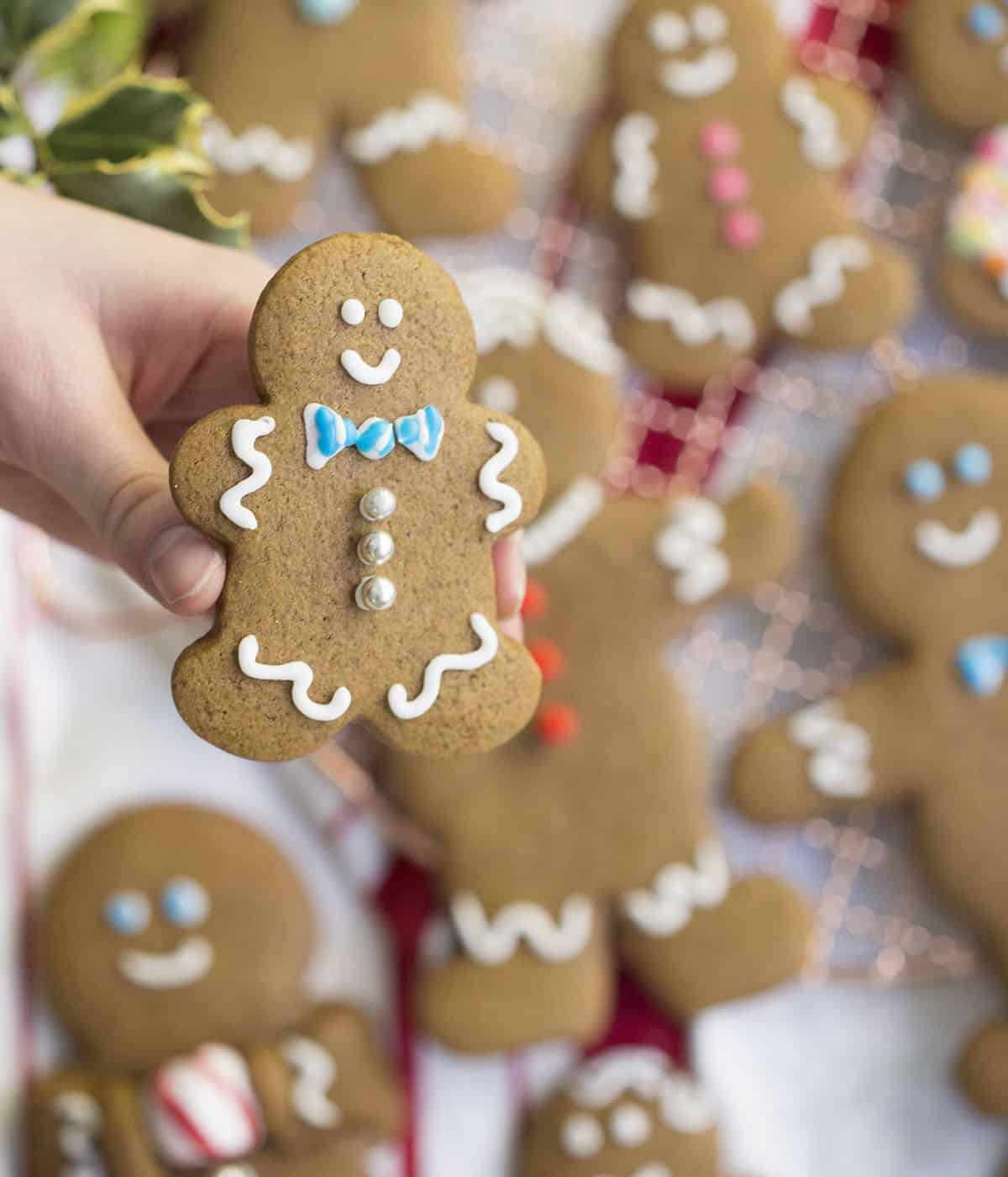 A gingerbread cookie held in the air.