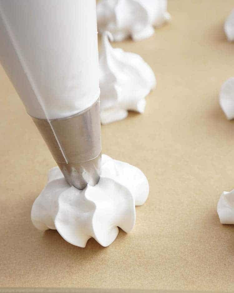 Meringue cookies piped with a piping tip.