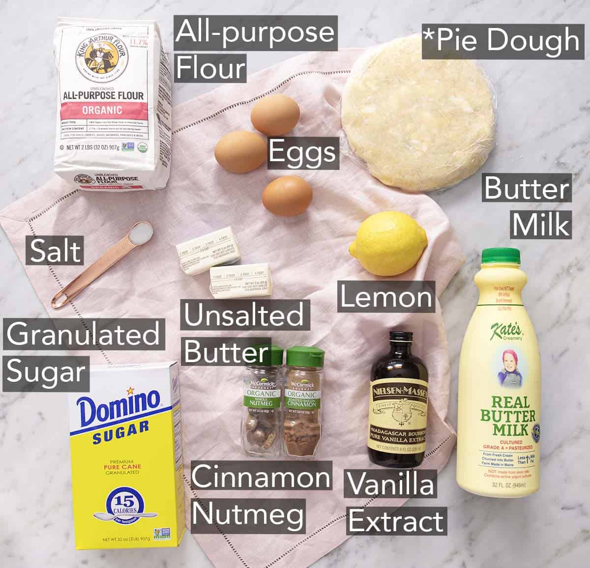 Ingredients to make buttermilk pie on a marble counter.