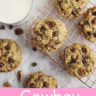 Pinterest graphic of an overhead view of cowboy cookies on cooling rack and a glass of mine beside it.