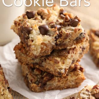 Pinterest graphic of three magic cookie bars on a plate next to some milk in a glass.